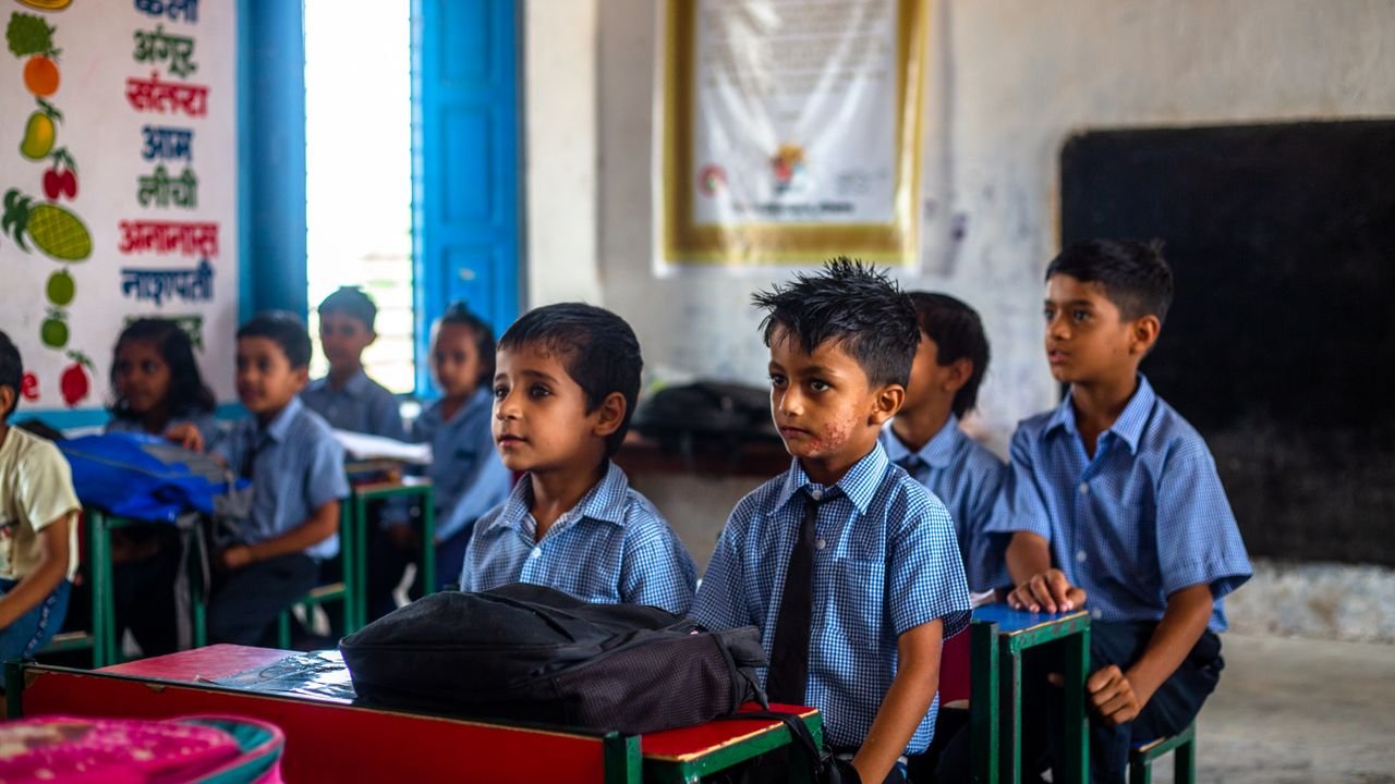 Home Indian school children in uniforms attentively listening in class.