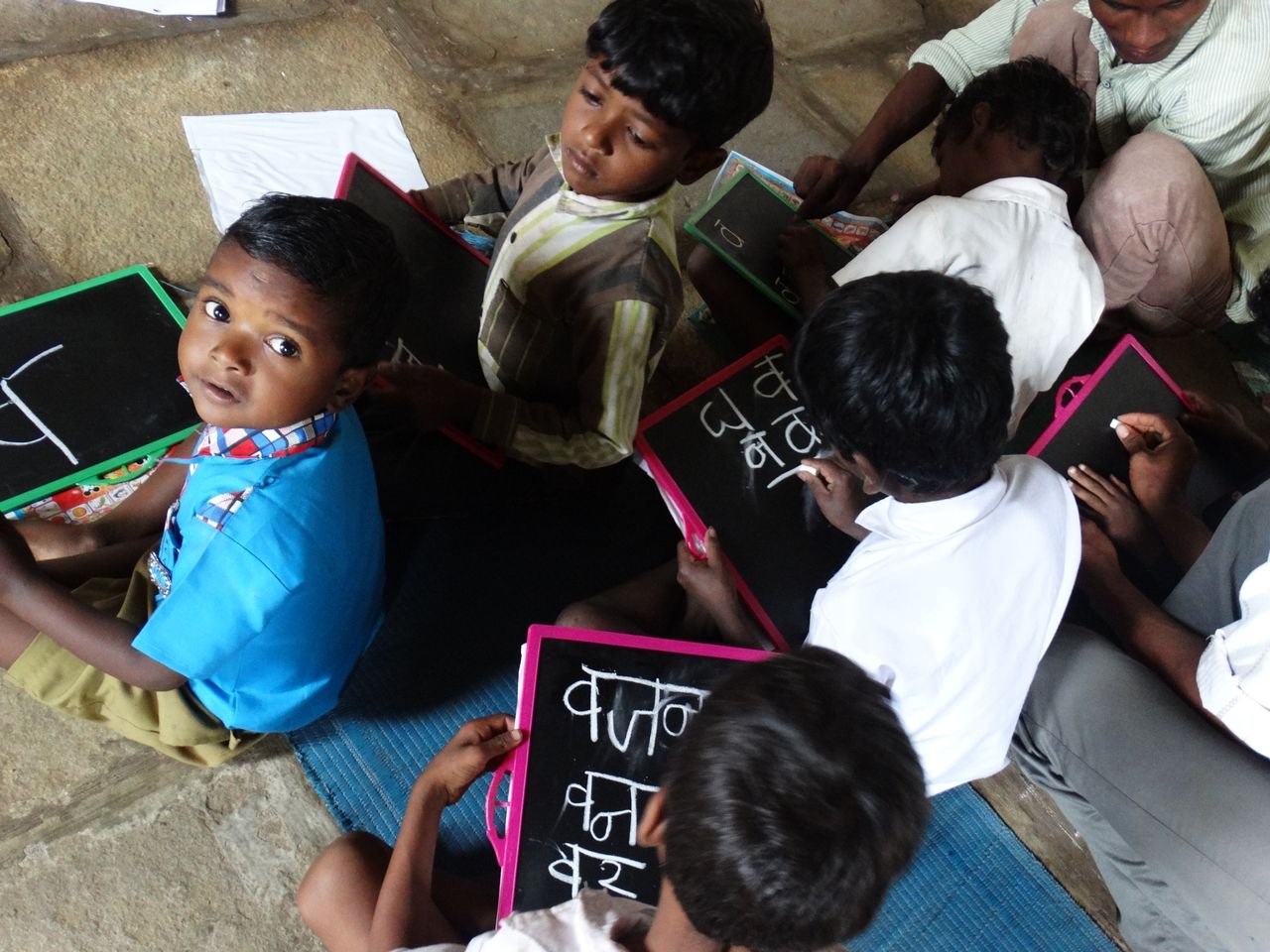 Offerings Young students writing on slates in a village school in Melghat, India.
